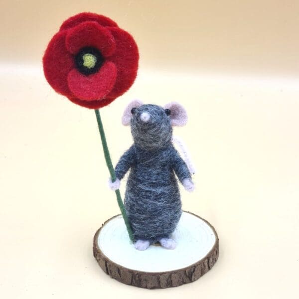 grey needle felted mouse holding a poppy