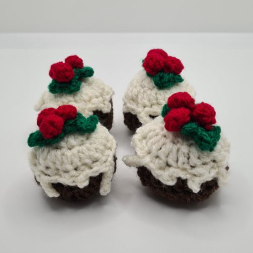 group of four crocheted christmas puddings