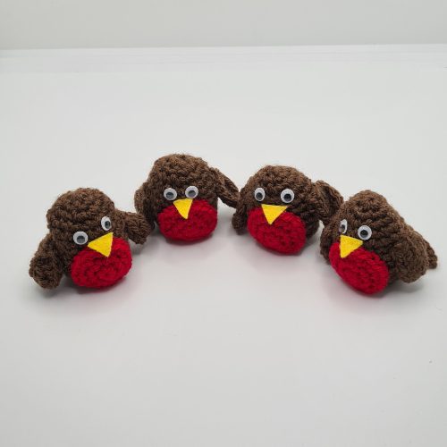 line of four crocheted robins