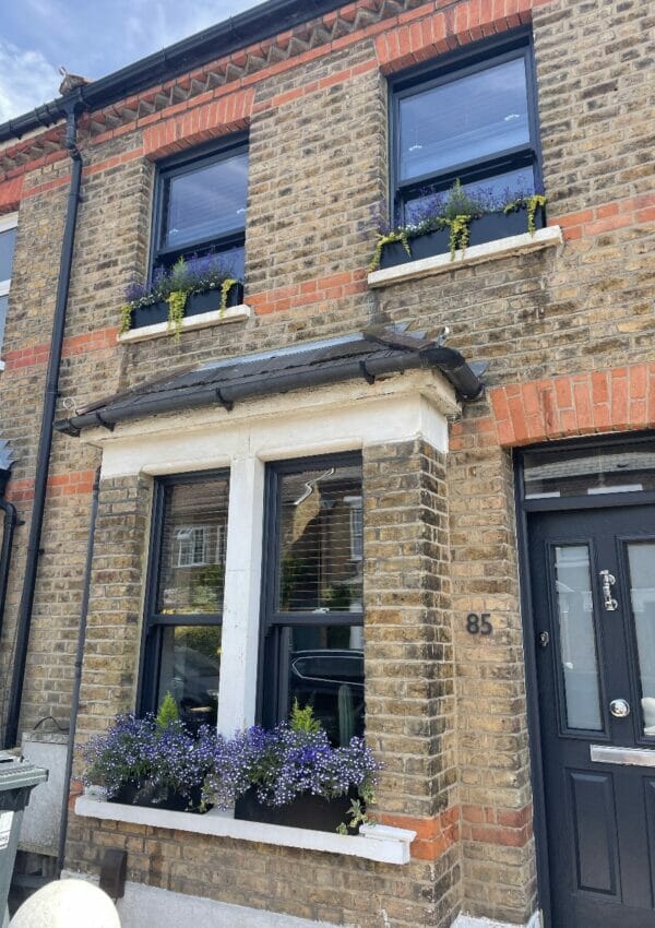 London living windows, black metal window sill planter boxes with heathers
