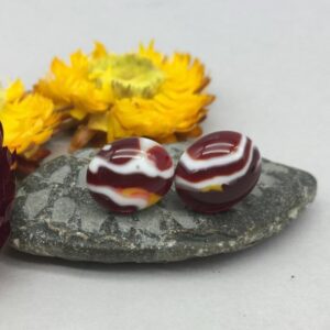 handmade glass cabochon stud earrings. Deep red with white and yellow pattern the stud earrings are set on sterling silver posts and butterfly fsteners