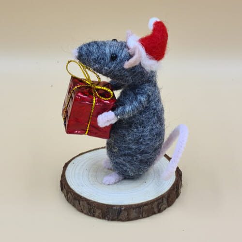 side view of grey mouse with present