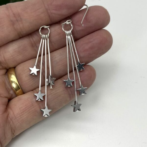 silver-plated stars hanging at different lengths from silver plated wires and connected to handmade sterling silver ear wires