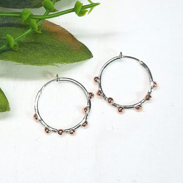 Silver hoop earrings with copper bobbles