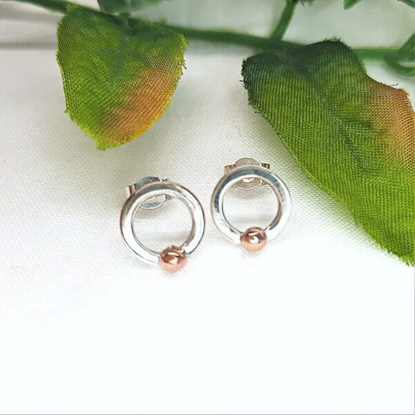 Silver stud earrings. Ring shaped with copper bobble bead at base.