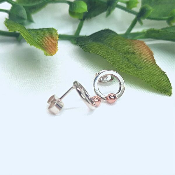 Silver stud earrings. Ring shaped with copper bobble bead at base.