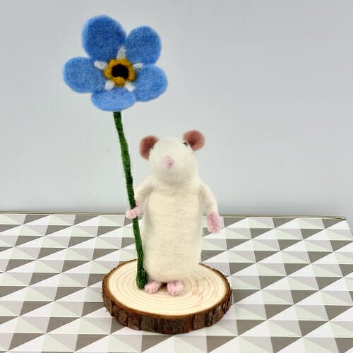 white needle felted mouse holding a forget-me-not flower