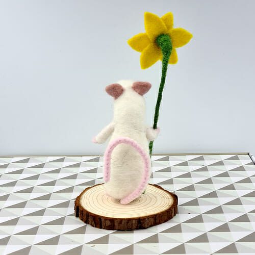 back view of needle felted white mouse holding a daffodil