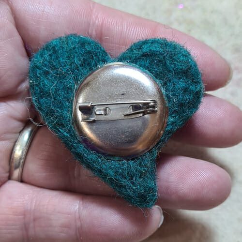 Back of wool heart brooch with metal clasp