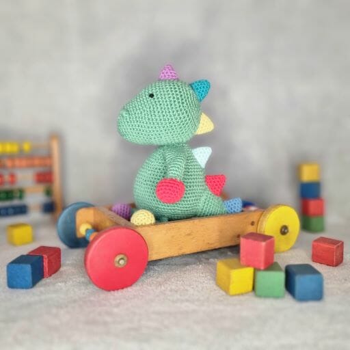 Rory the dinosaur sat showing off his colourful 'spikes'