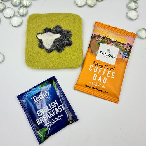 needle felted green coaster with grey sheep and tea or coffee bag