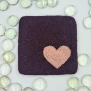 Needle felted damson coloured coaster with dusky pink heart