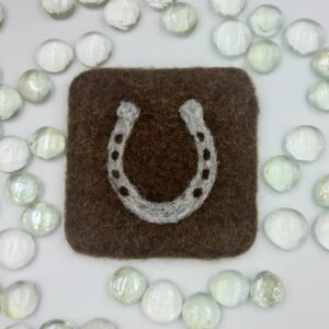 needle felted coaster featuring grey horseshoe