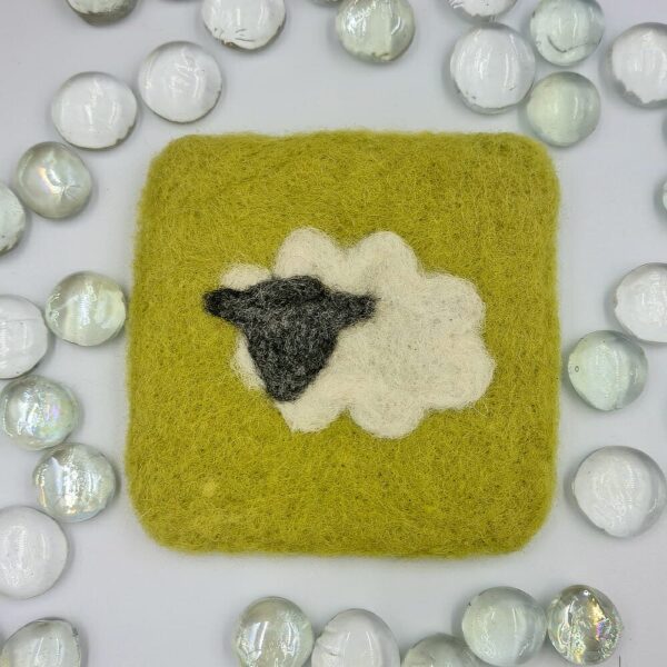 needle felted green coaster with white sheep