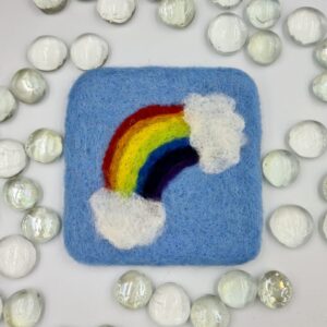 needle felted coaster with rainbow and clouds