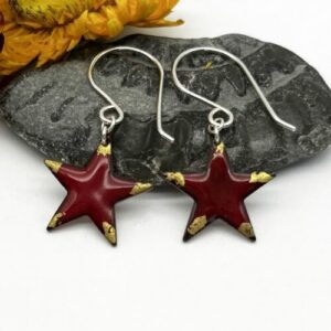 small star earrings with rich red enamel trimed on each spike with real gold leaf. suspended from silver ear wires