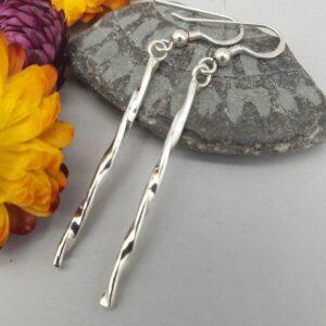 silver long drop twisted pattern earrings