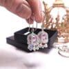Beaded silver coronation crown earrings.