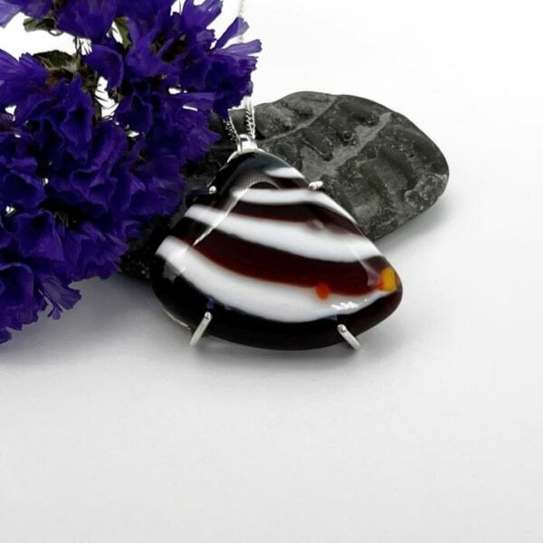 Fan or shell shaped fused glass pendant prong set in silver. Colours of red and white stripy pattern. on a silver chain