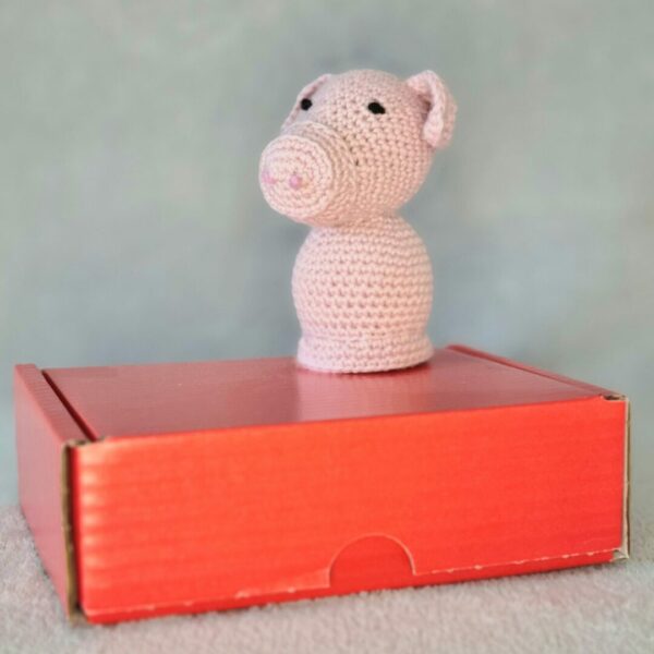 Red postage box used for holding soft toy pig