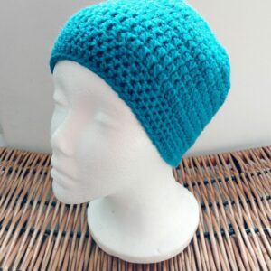 Crochet sea blue classic beanie hat. Photographed on white mannequin head.