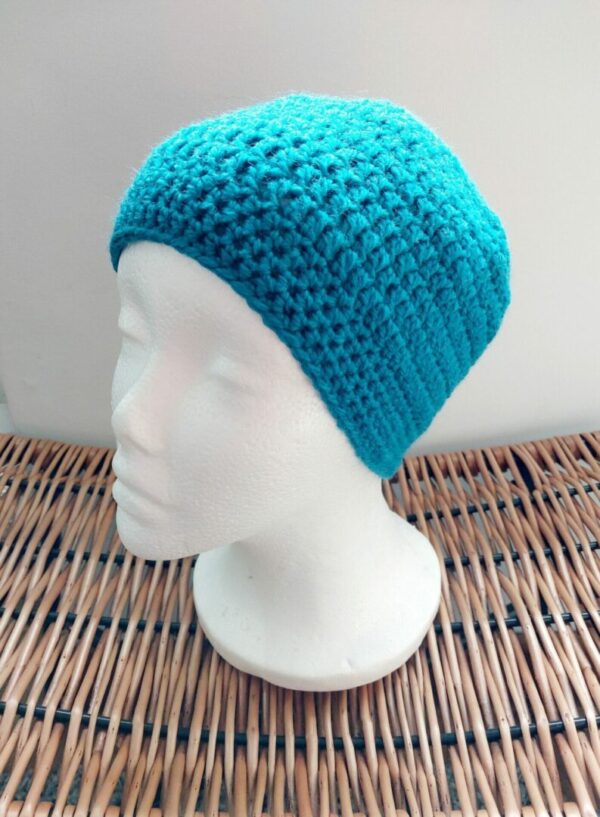 Crochet sea blue classic beanie hat. Photographed on white mannequin head.