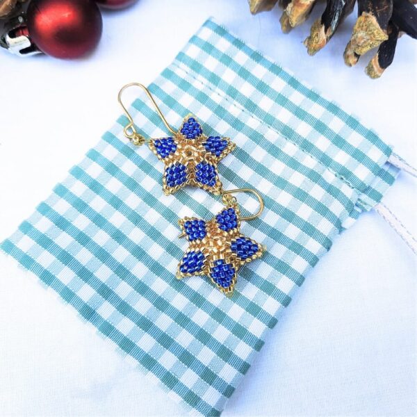 Christmas star earrings in blue with gold.