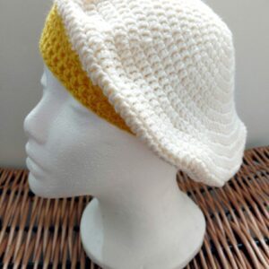 Cream crochet beret hat with golden yellow brim.