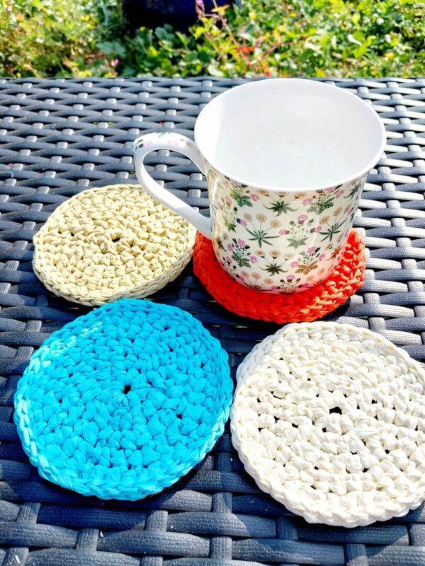 Set of 4 Raffia coasters in natural, cream, blue and red.
