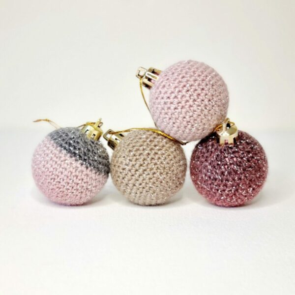 4 crochet sparkly baubles stacked together on a white background.