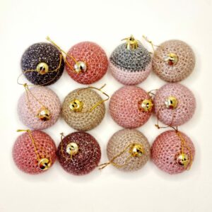 Blush and neutral shaded of 12 sparkly baubles on a white background.