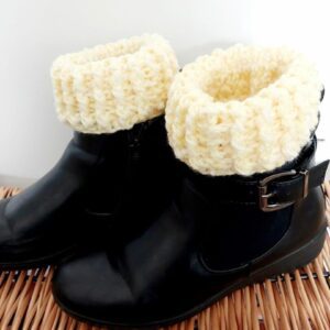 Lemon yellow crochet boot cuffs shown short in black shoes.