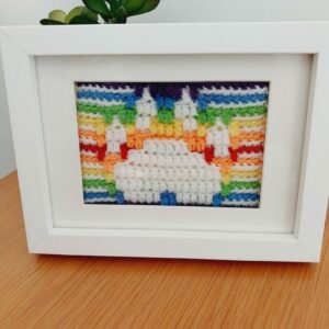 Mosaic Crochet Picture of a white Paw Print with rainbow border and background.