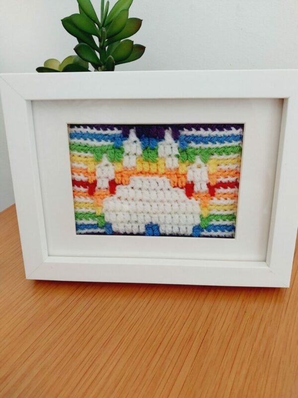 Mosaic Crochet Picture of a white Paw Print with rainbow border and background.