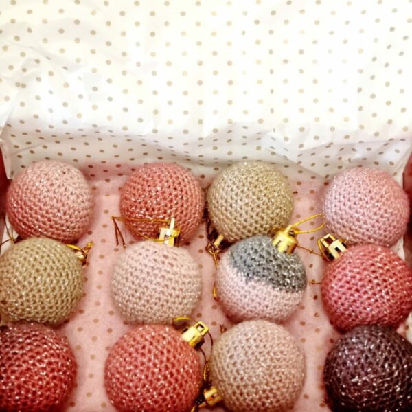 Blush and rose coloured sparkly baubles in a gift box with gold polka dot paper.