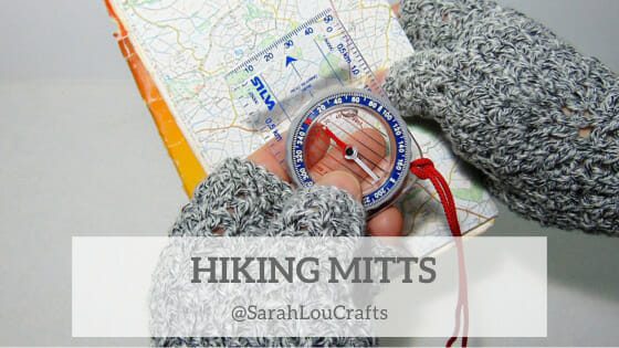 Model wearing great fingerless gloves, hiking mitts holding a map and a compass.