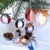 Silver and gold satin Christmas baubles with a glittery bow on top. Paired with colour variations of red, blue and black.