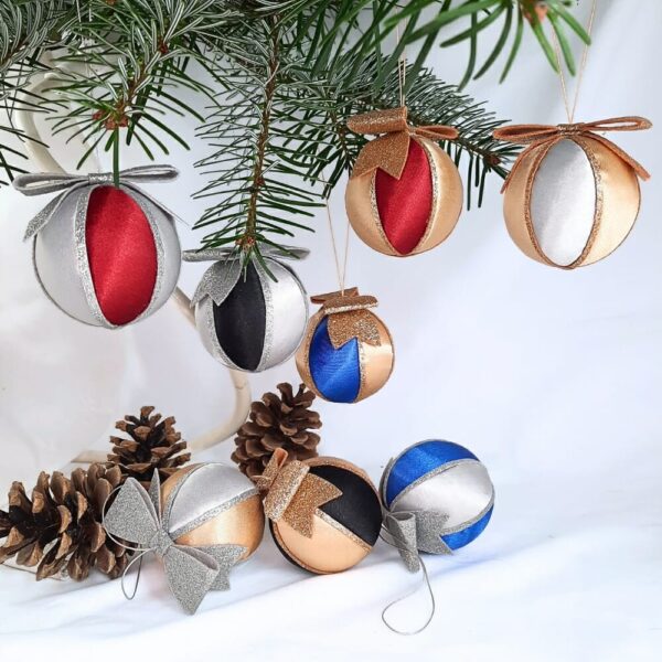 Silver and gold satin Christmas baubles with a glittery bow on top. Paired with colour variations of red, blue and black.
