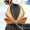 Gold and black satin Christmas bauble with a glittery bow on top.