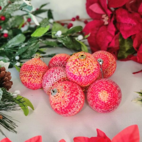 Pink and peach baubles surrounded by Christmas foliage