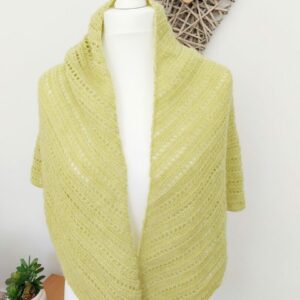 Crochet triangle shawl wrap in a soft sunflower yellow shown draped on white mannequin.
