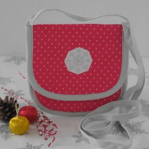 Small red crossbody bag in polka dot fabric with appliqued snowflake on front flap
