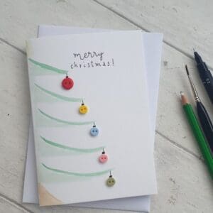 Watercolour Christmas cards with added buttons as baubles and the message 'Merry Christmas'