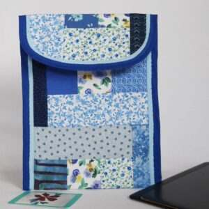 Tablet case made from a patchwork of blue patterned cotton fabrics, shown with an electronic tablet.