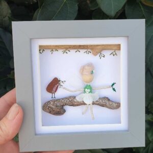 Mor Maids miniature fairy sitting on a driftwood branch with a robin red breast made using sea glass.