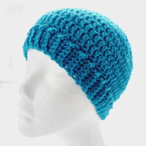 Crochet classic beanie hat with brim in a sea blue aran yarn, shown on a white mannequin head.