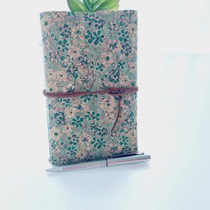 Cork fabric notebook journal with green floral pattern and brown faux suede wrap tie.