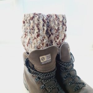 Crochet boot cuff ankle warmers, in a variegated yarn of brown, blue and cream shades. Shown in brown hiking boots.