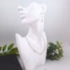 Dangly earrings with round jade gemstone beads and hand crafted silver swirl in a stylised curl shape and matching necklace.