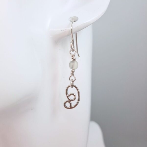 Dangly earrings with round jade gemstone beads and hand crafted silver swirl in a stylised curl shape.